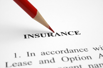 insurance paperwork with red colored pencil pointing to the word insurance