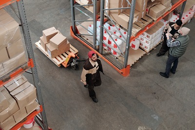 person moving boxes in facility